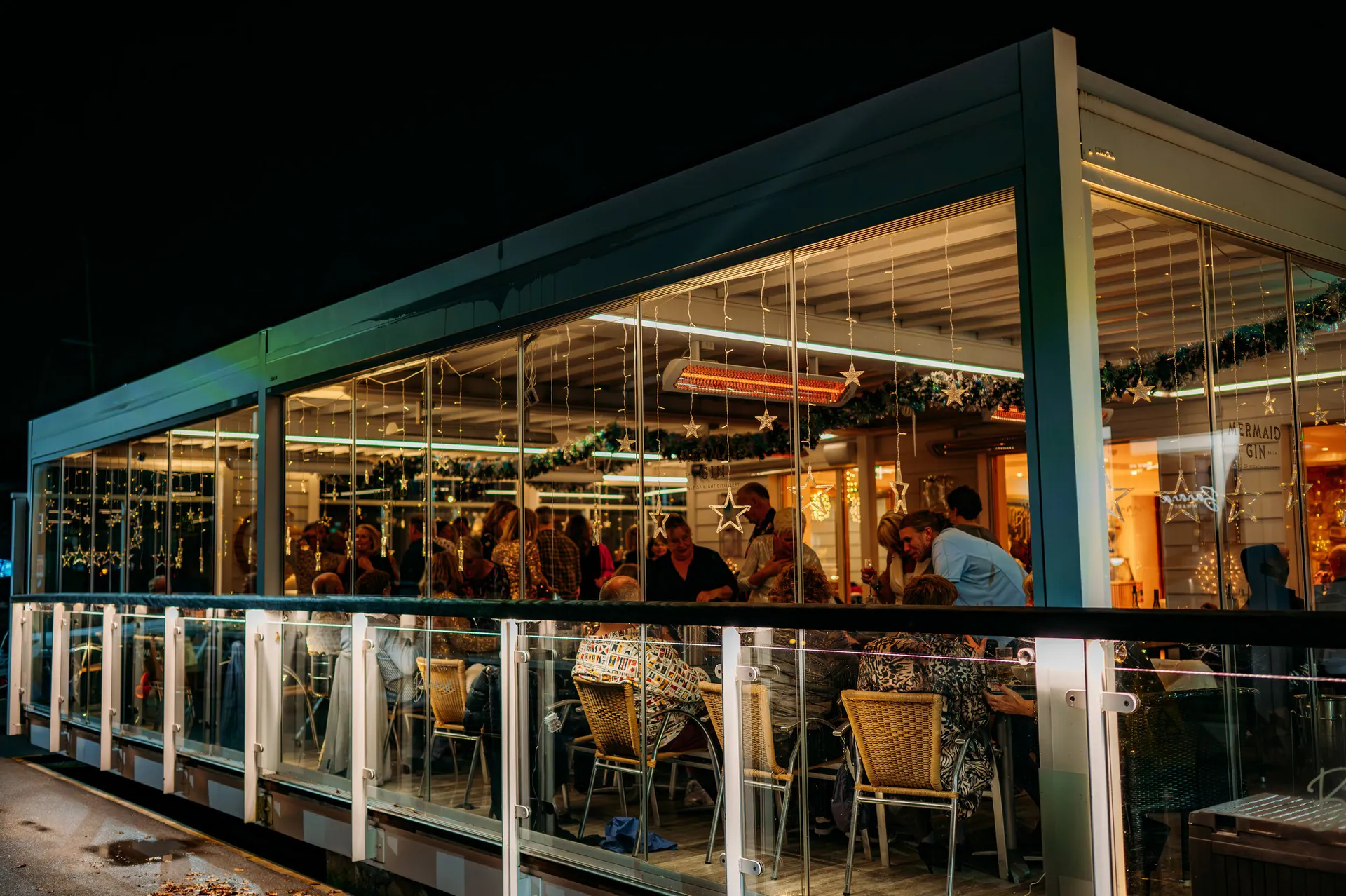 The Pergola at Port Hamble at night, decorated for Christmas and full of guests